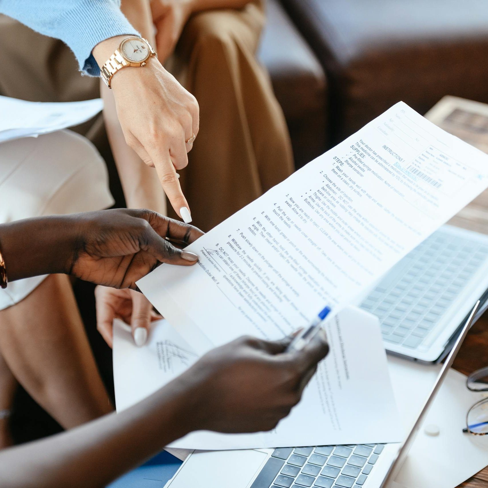 Multiethnic businesswomen checking information in documents