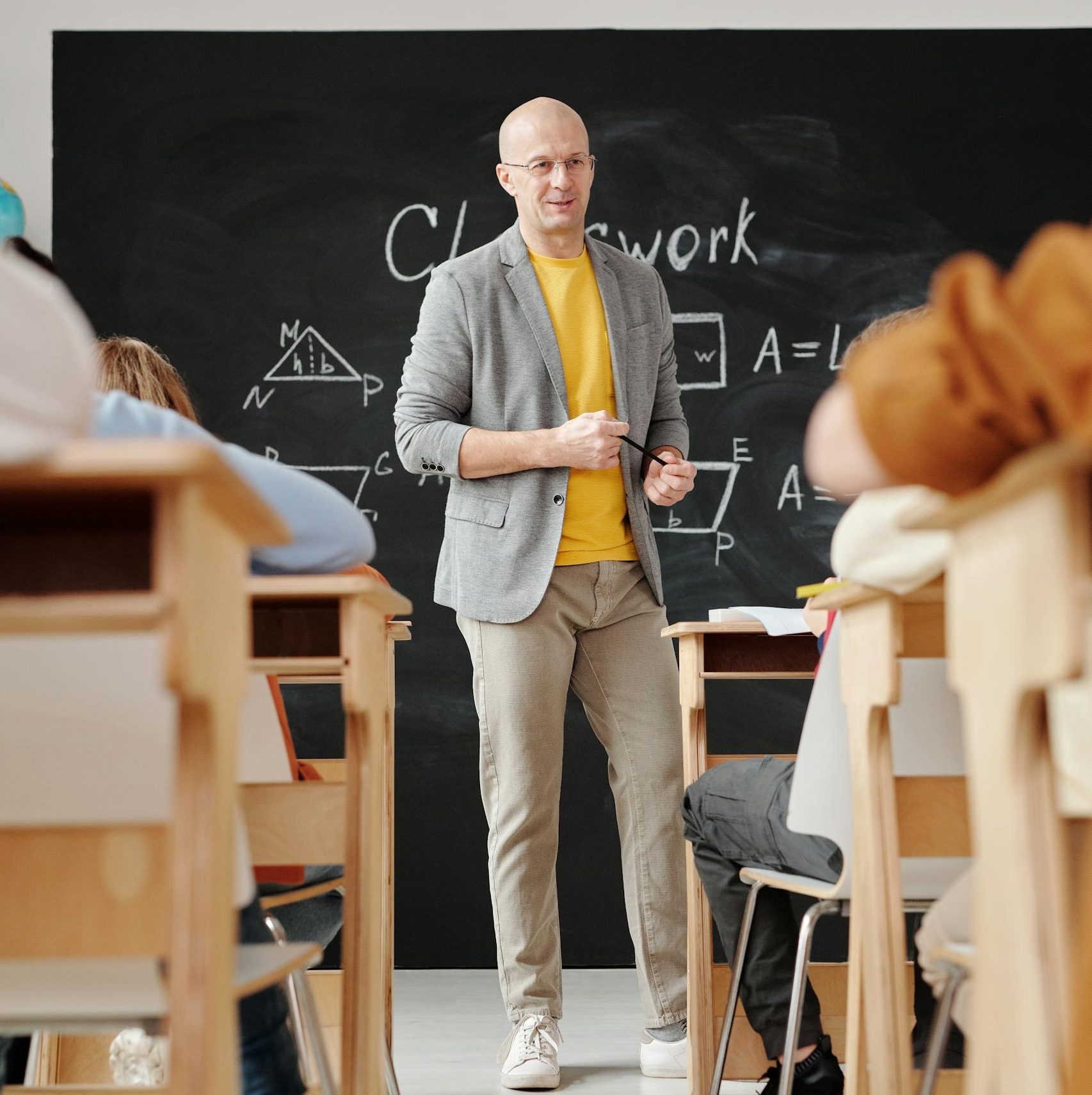 Teacher Standing in Front of a Blackboard