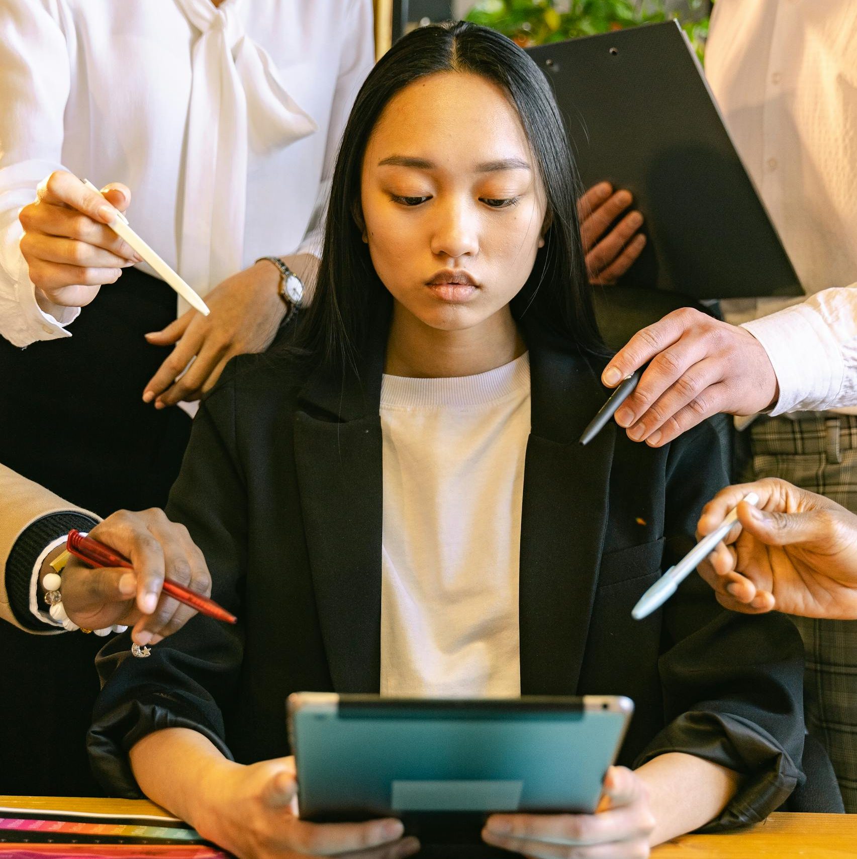 Woman Using Ipad Brainstorming with Her Colleagues